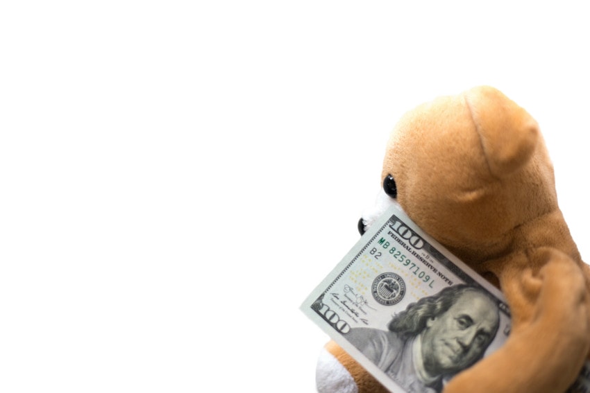 teddy bear holding 100 bill scaled